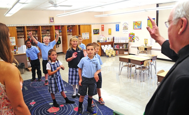 Bishop Richard J. Malone greets students at Our Lady of Blessed Sacrament School during their first day of school.
Dan Cappellazzo/Staff Photographer 